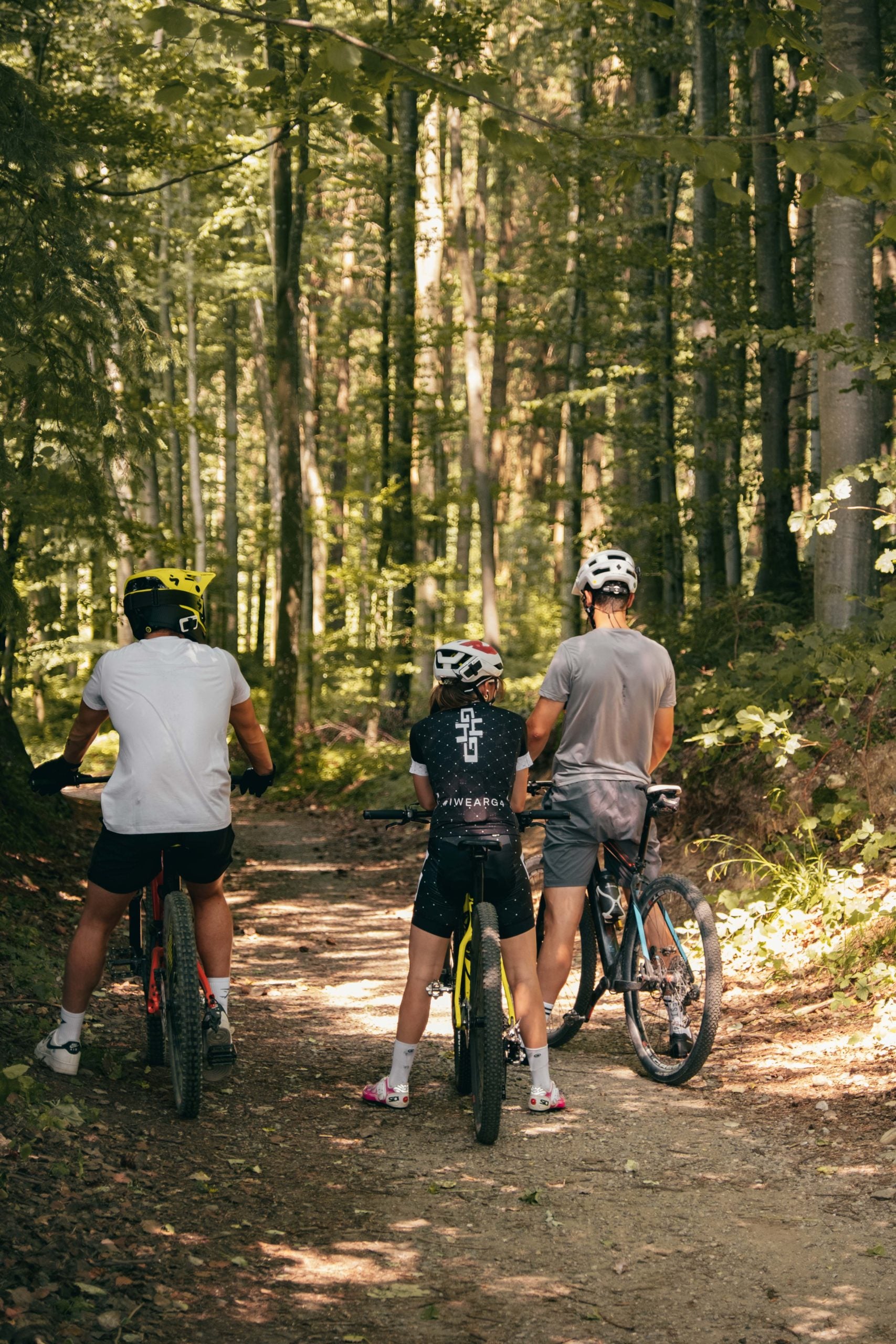 Cardo systems NZ | Packtalk outdoor being used with three mountain bikers in the forest 