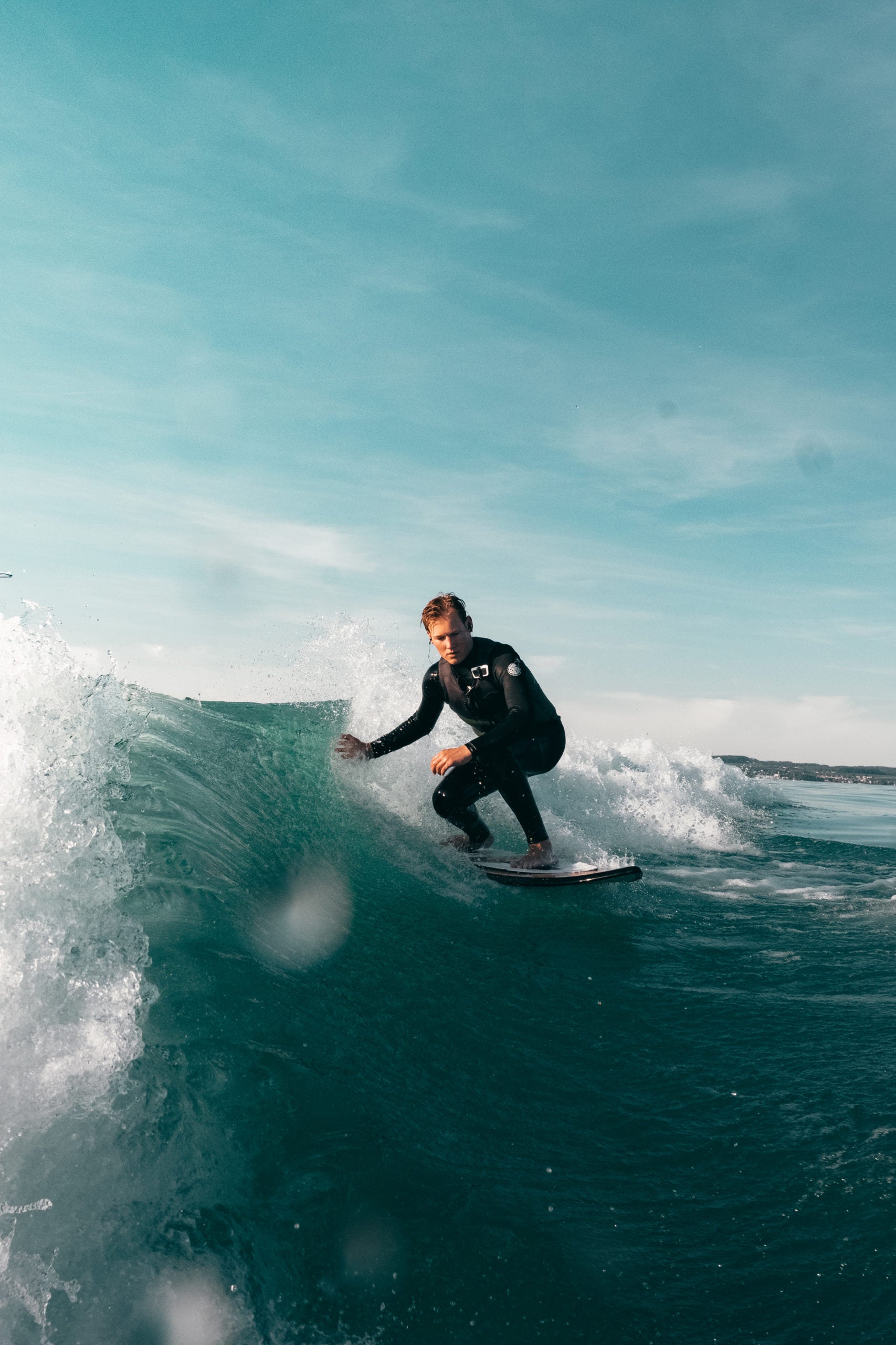 Cardo systems NZ | Packtalk outdoor shown on surfer riding a wave